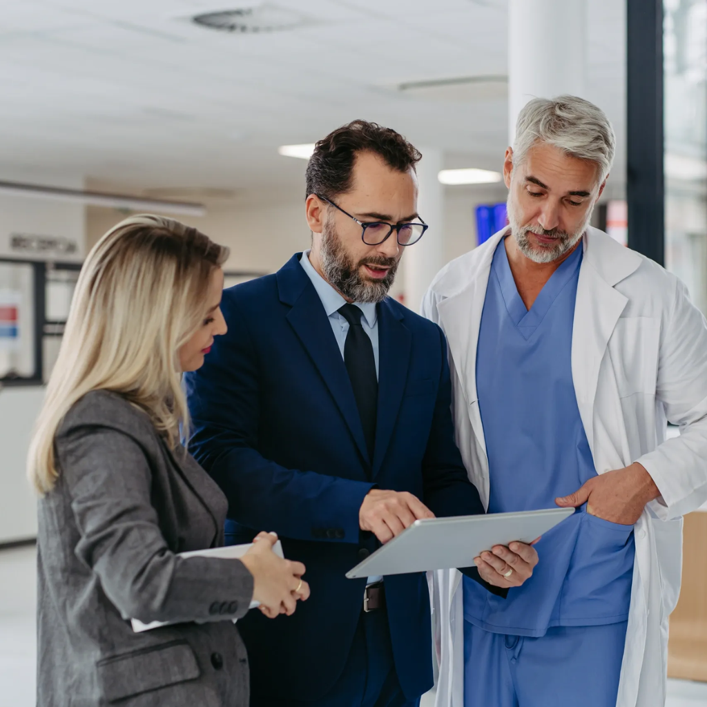 Healthcare professionals consulting and reviewing compliance documentation
